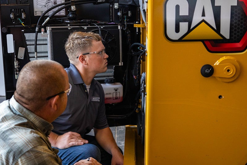 Peterson Cat tech working on a machine