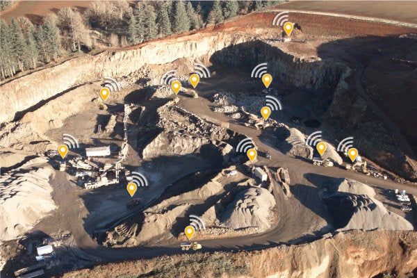 Drone photo of a quarry with yellow map marker icons on most of the machines