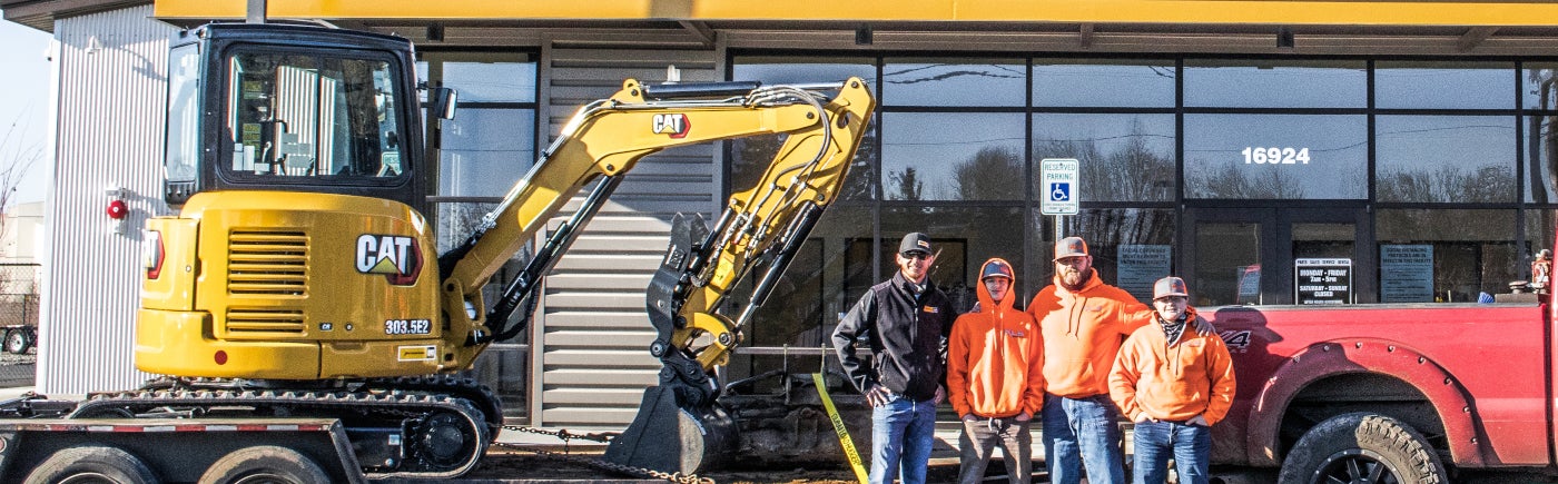 A family picking up their new Cat mini excavator from Peterson Cat in Ridgefield, Washington